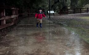 Kid Plays Outside on Rainy Day