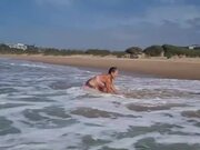 Woman Sitting in Chair Gets Knocked Back by Waves