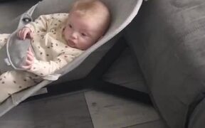 Puppy Rocks Baby in His Bouncer With His Paw
