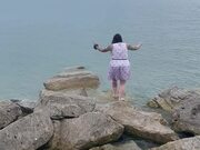 Woman Walking on Rocks Loses Footing and Falls