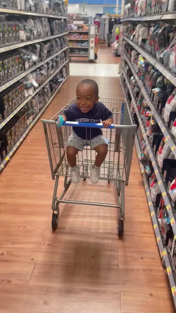 Kid Sitting Inside a Cart Laughs Hysterically