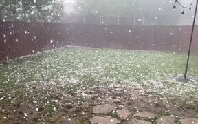 Person Watches Heavy Hailstorm Cover Backyard