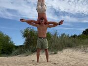 Gymnast Balances on Handstand Over Acrobat