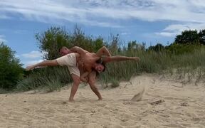 Gymnast Duo Flips Like Human Wheel at Beach