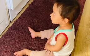 Toddler Curiously Looks at Clothes Spinning