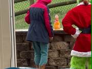 Person Dressed up as Grinch Character Scares Boy