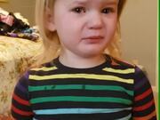 Crying Toddler Pretends to Smile in Front of Mom
