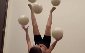 Artist Juggles Balls While Lying on Her Back