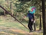 Man Juggles Spinning Cloth on Slack Line