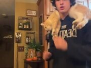 Person Dances With His Pet Cat on His Shoulders