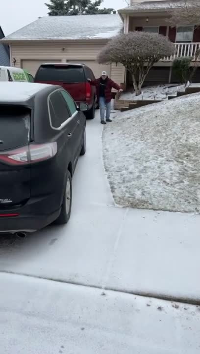 Guy Slips Down Icy Driveway and Slams Into Car