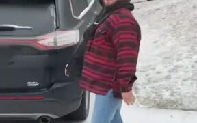 Guy Slips Down Icy Driveway and Slams Into Car
