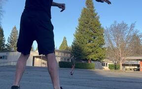 Guy on BalanceBoard Plays Catch With Skateboarder