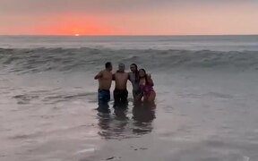 Family Gets Swept by Huge Wave While Posing
