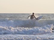 Tracking Shot of a Man Surfing in the Sea