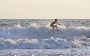 Tracking Shot of a Man Surfing in the Sea - Sports - VIDEOTIME.COM