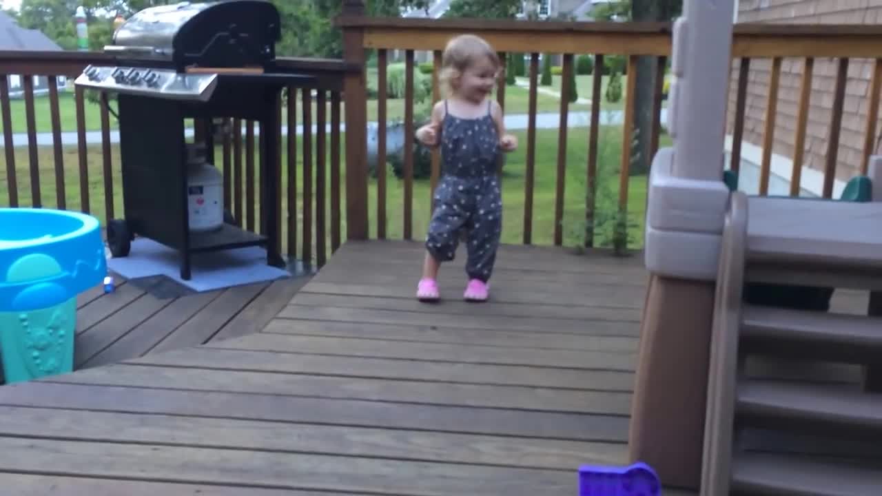 Toddler And Dog Dancing On Deck - Animals - Videotime.com