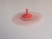 Whirling a Red Humming Top in Slow Motion