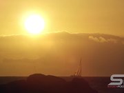 Static View of Sailboat on the Horizon at Sunset