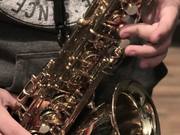 Musician Plays A Gold Saxophone Close Up
