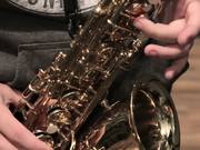 Musician Plays A Gold Saxophone Close Up